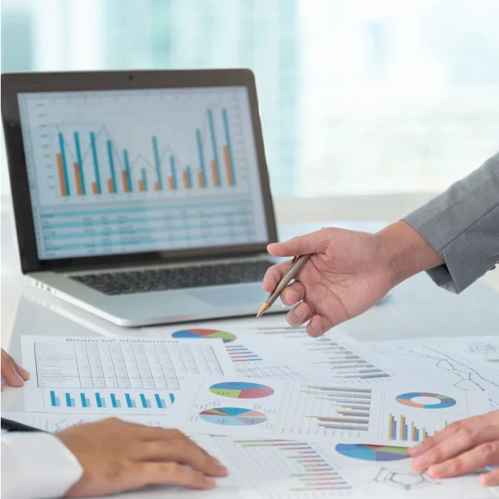 Business meeting with financial charts